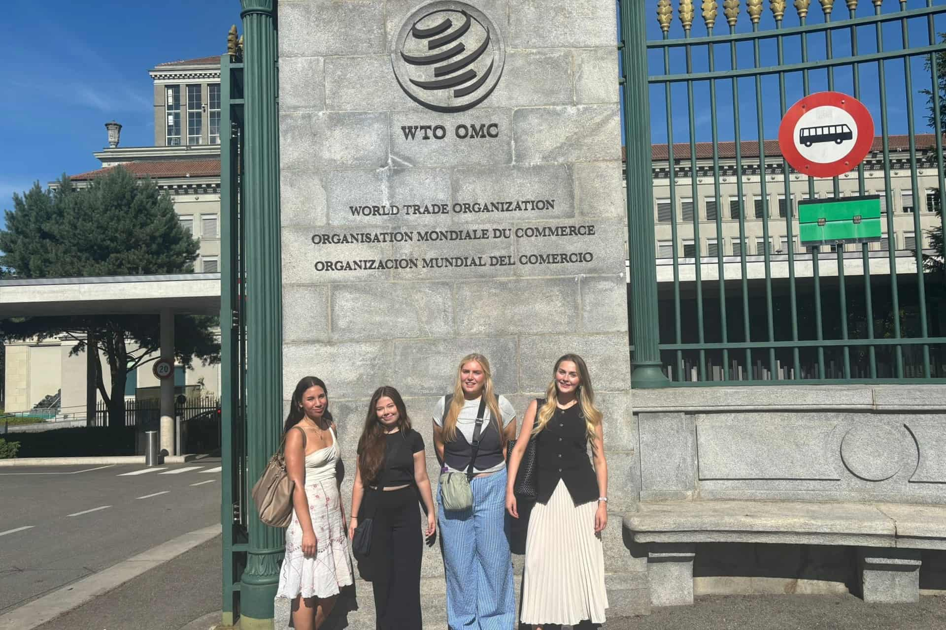 Students stand outside the World Trade Organization.