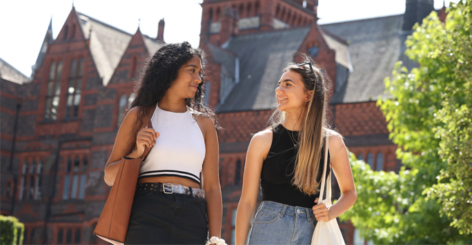 Two students walking through campus