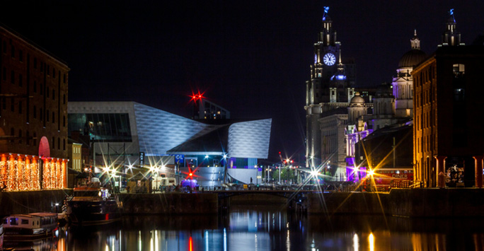 The Liverpool waterfront skyline at night.
