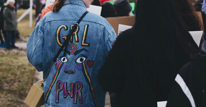 Denim jacket with design that reads 'Grl Pwr'