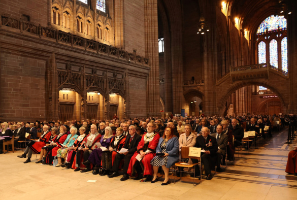 Rows of people sat inside the Liverpool Cathedral.