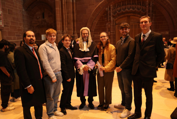 Liverpool Law School students stand with members of the Liverpool legal community.