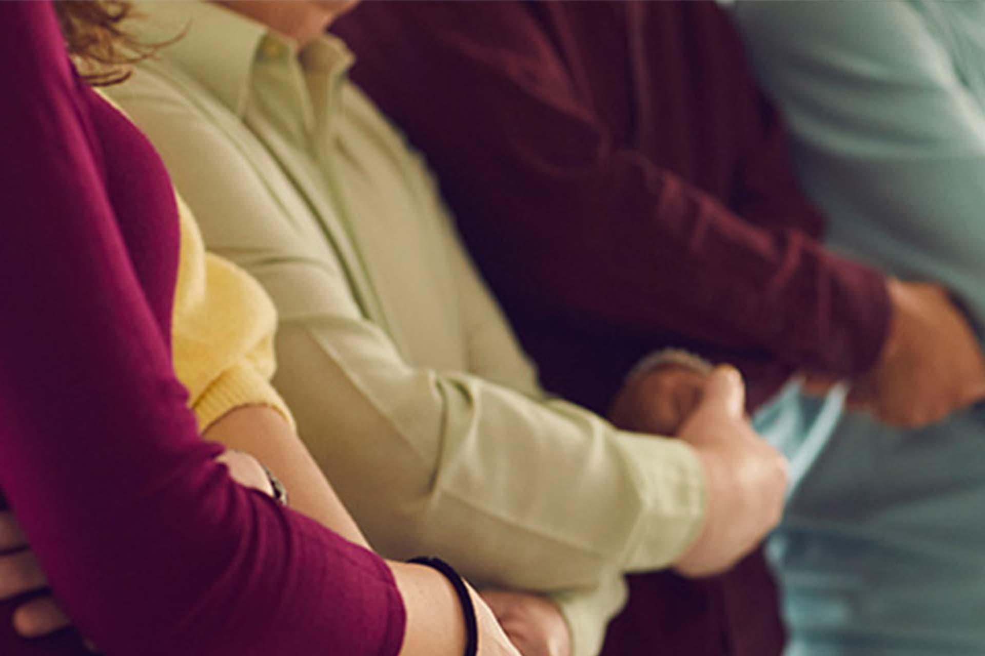 A row of people with folded arms.