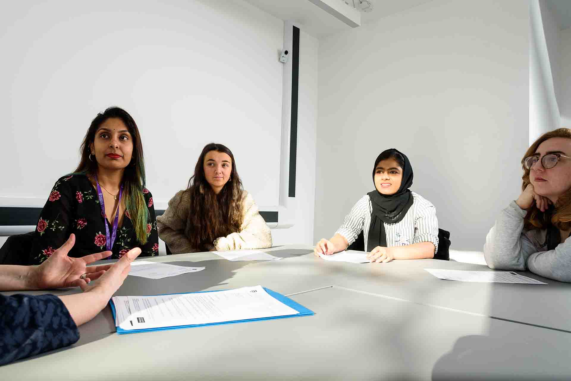 Law Clinic staff sat around a table discussing a case.