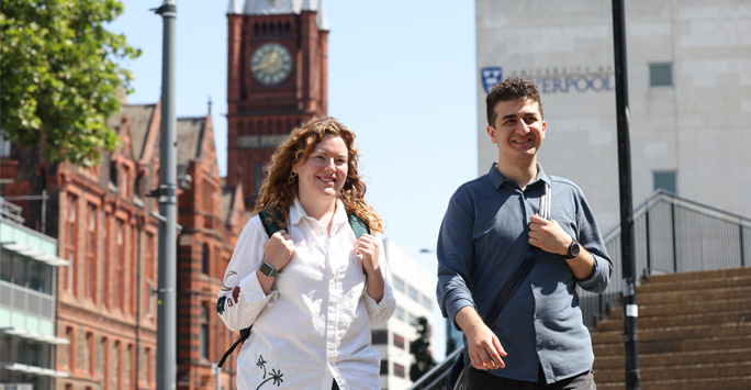 Two conference delegates walk through the University of Liverpool campus.