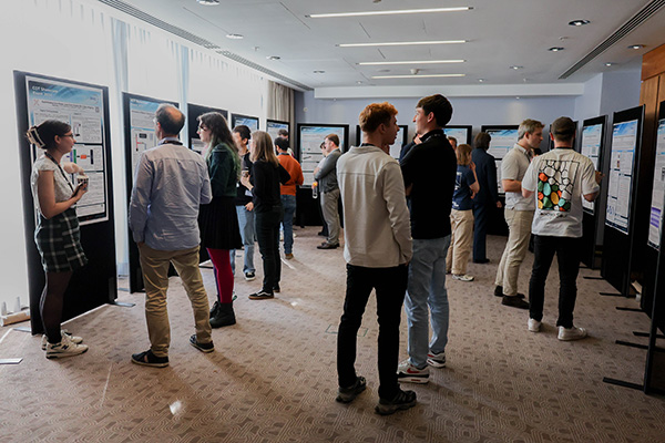 Several people at a poster session.