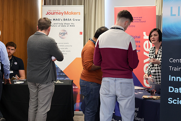 People looking at industry exhibition stands.