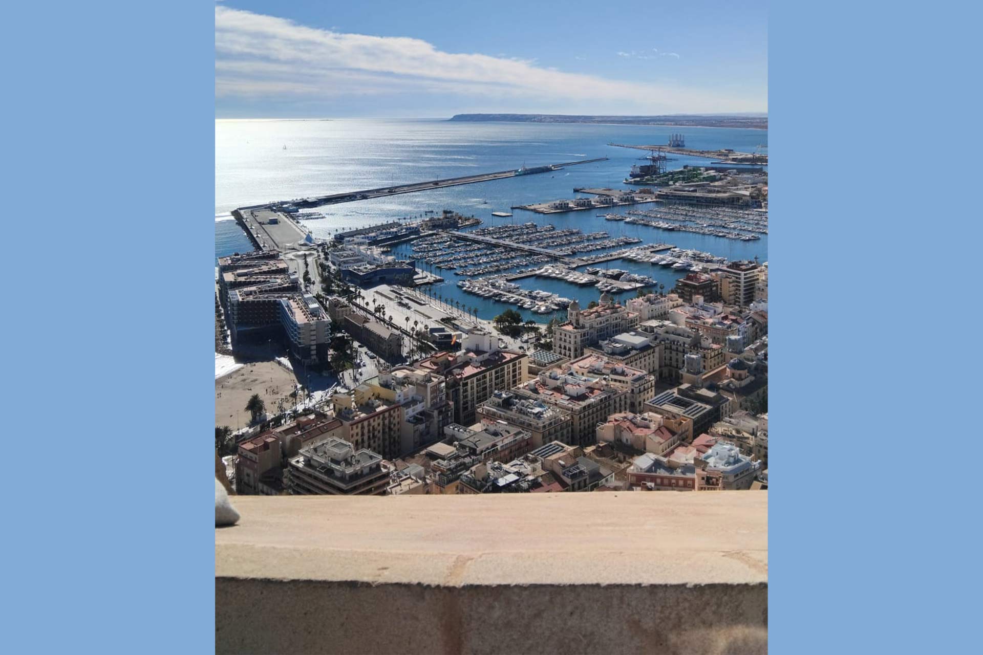 View from a castle wall overlooking a Mediterranean city waterfront