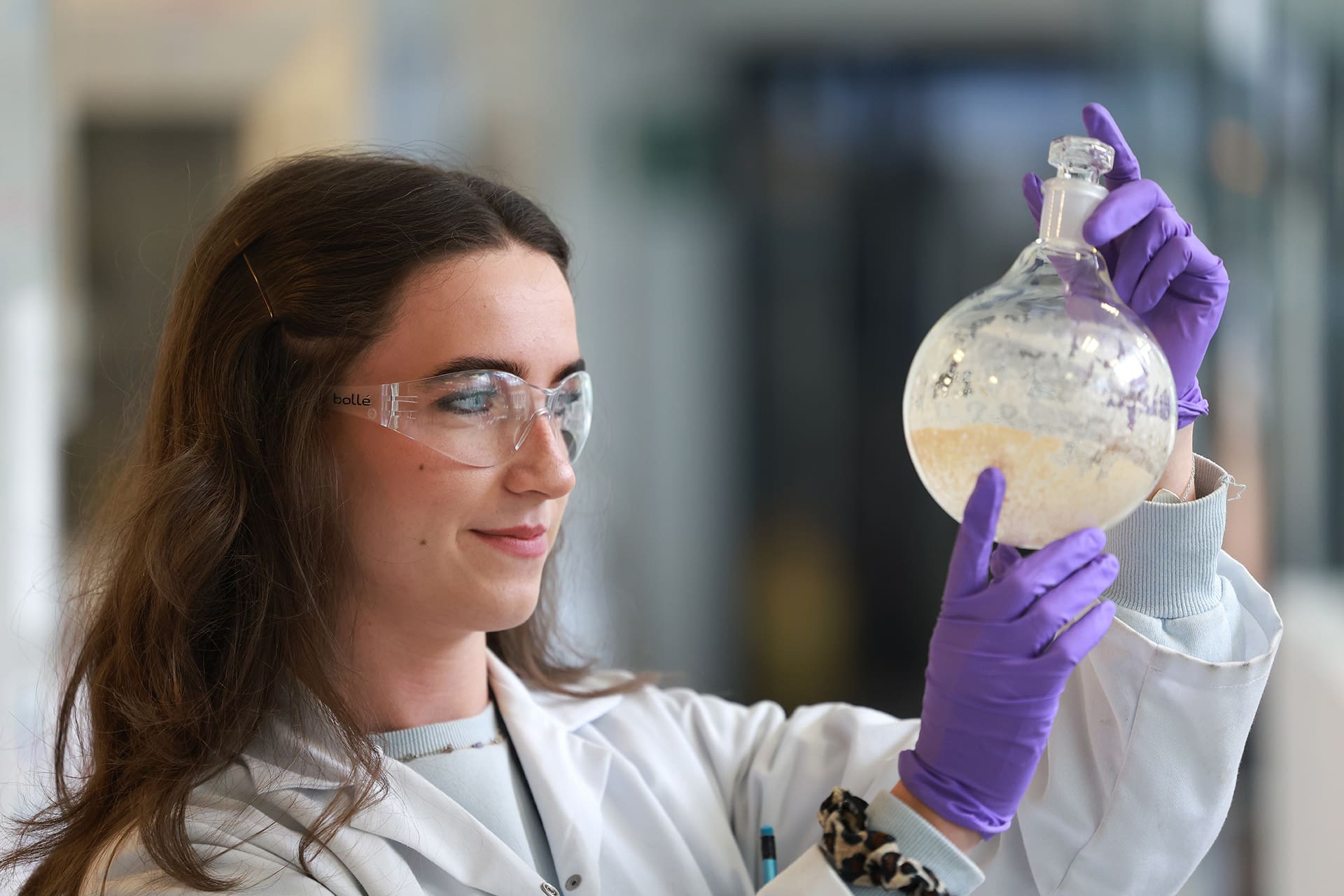 Scientist in lab looking at experiment