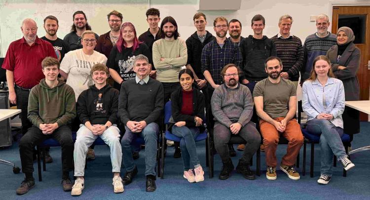 Nuclear physics group photo sitting together in 2 rows