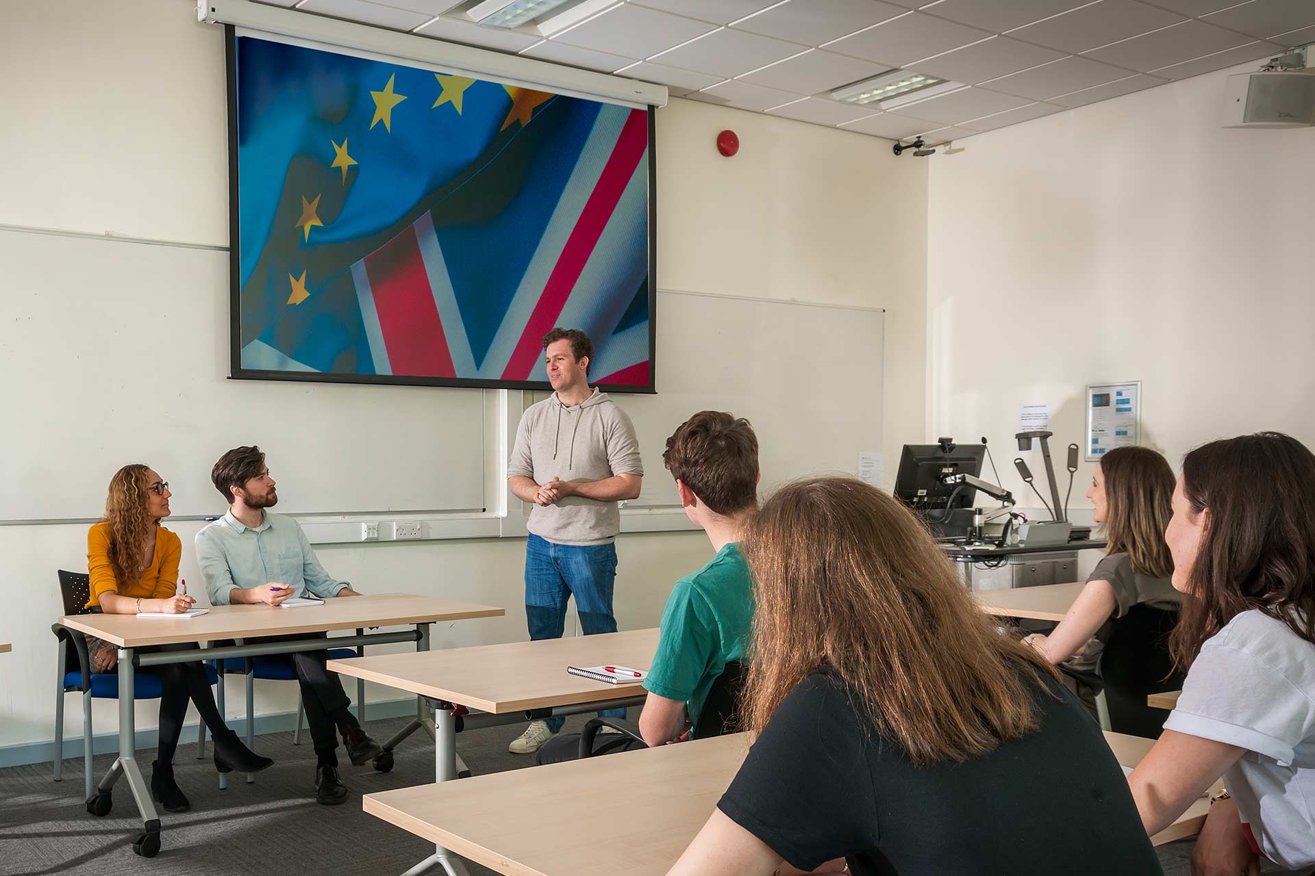 Students in a seminar with a teacher at the front