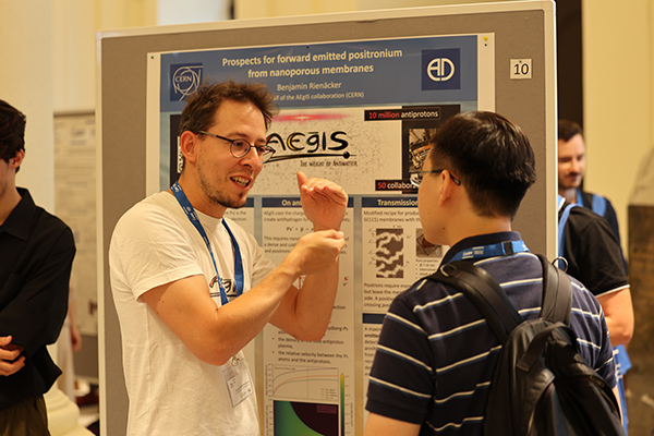 A person explaining something at a poster session.