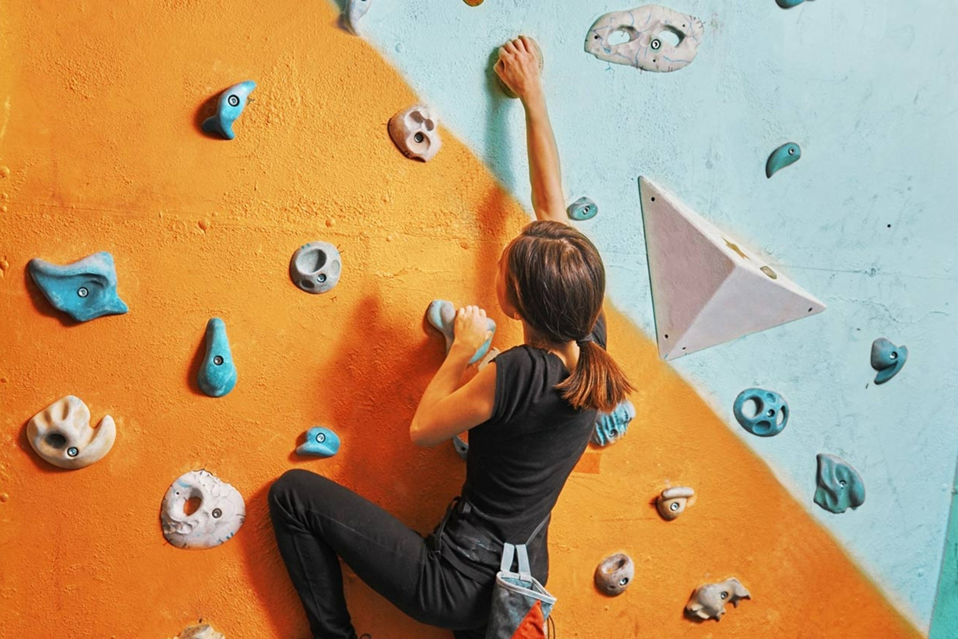 A person using the climbing wall in the University sports centre.