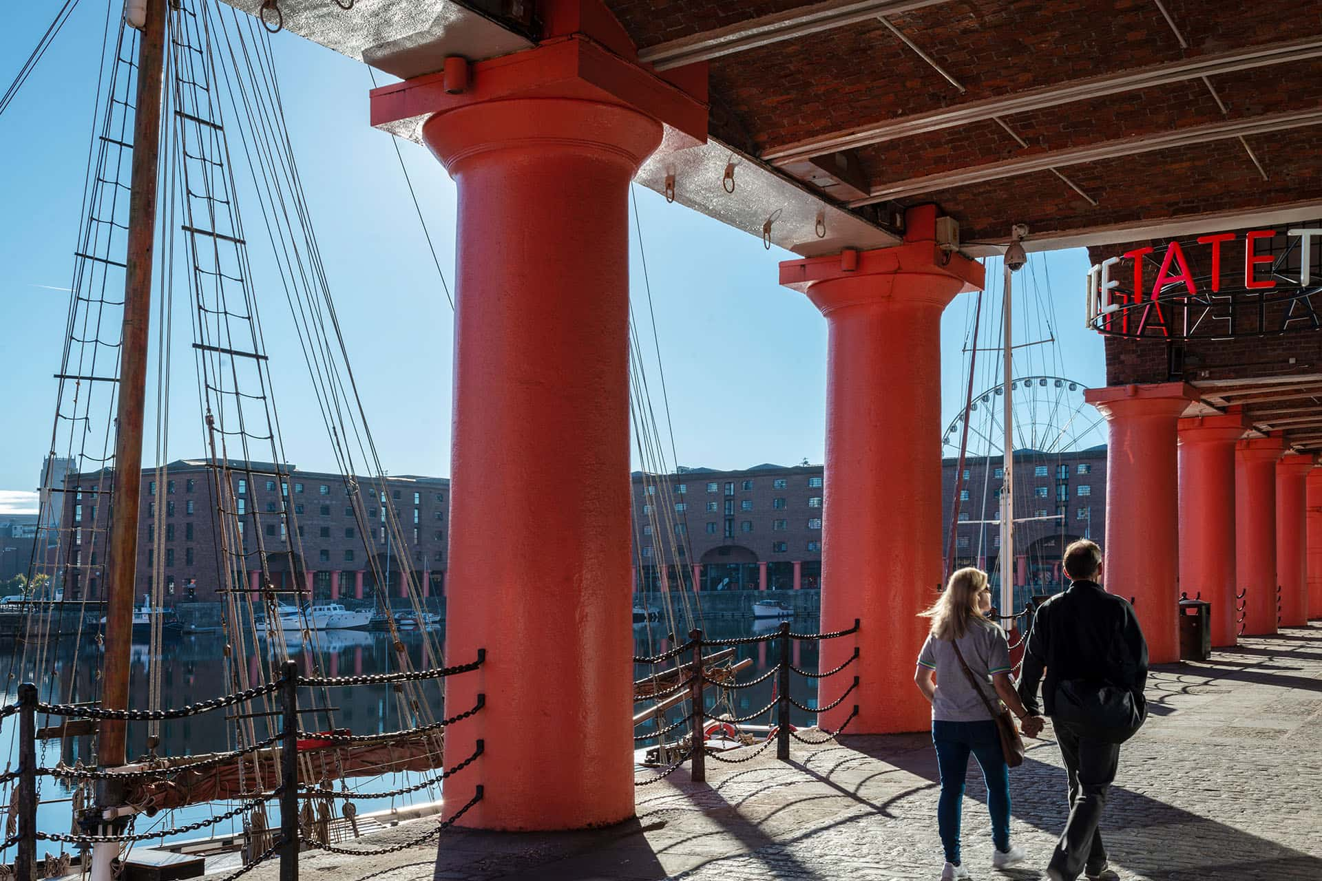 Albert Dock with red brick buildings and people walking