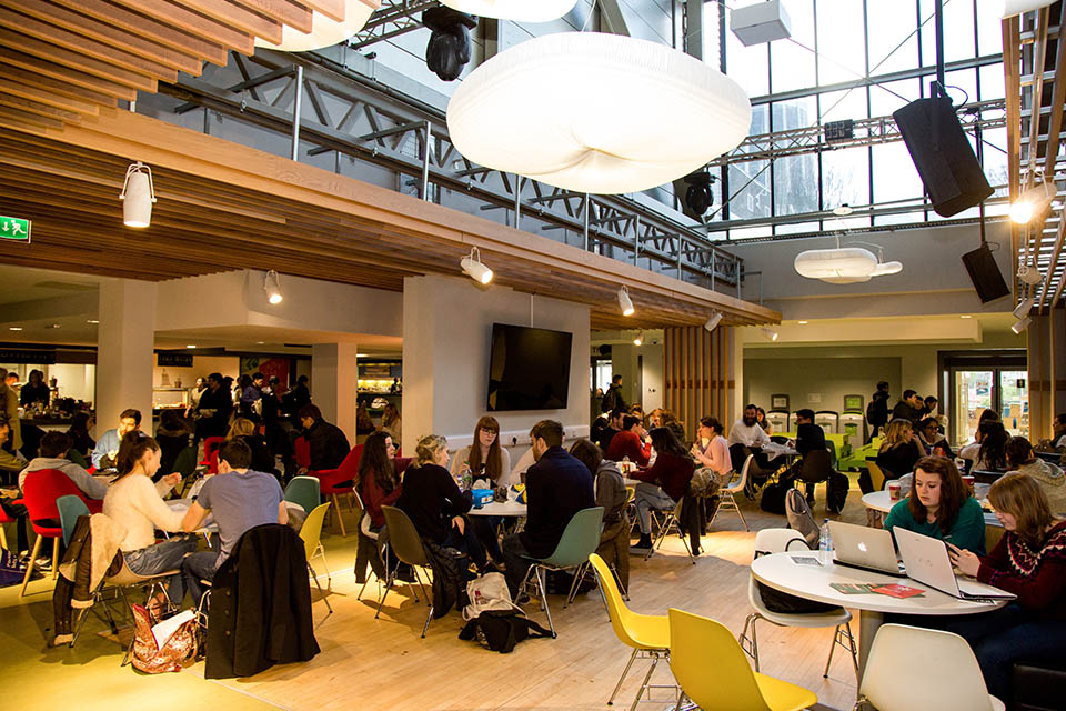 Guild of Students food courtyard with students sitting at tables