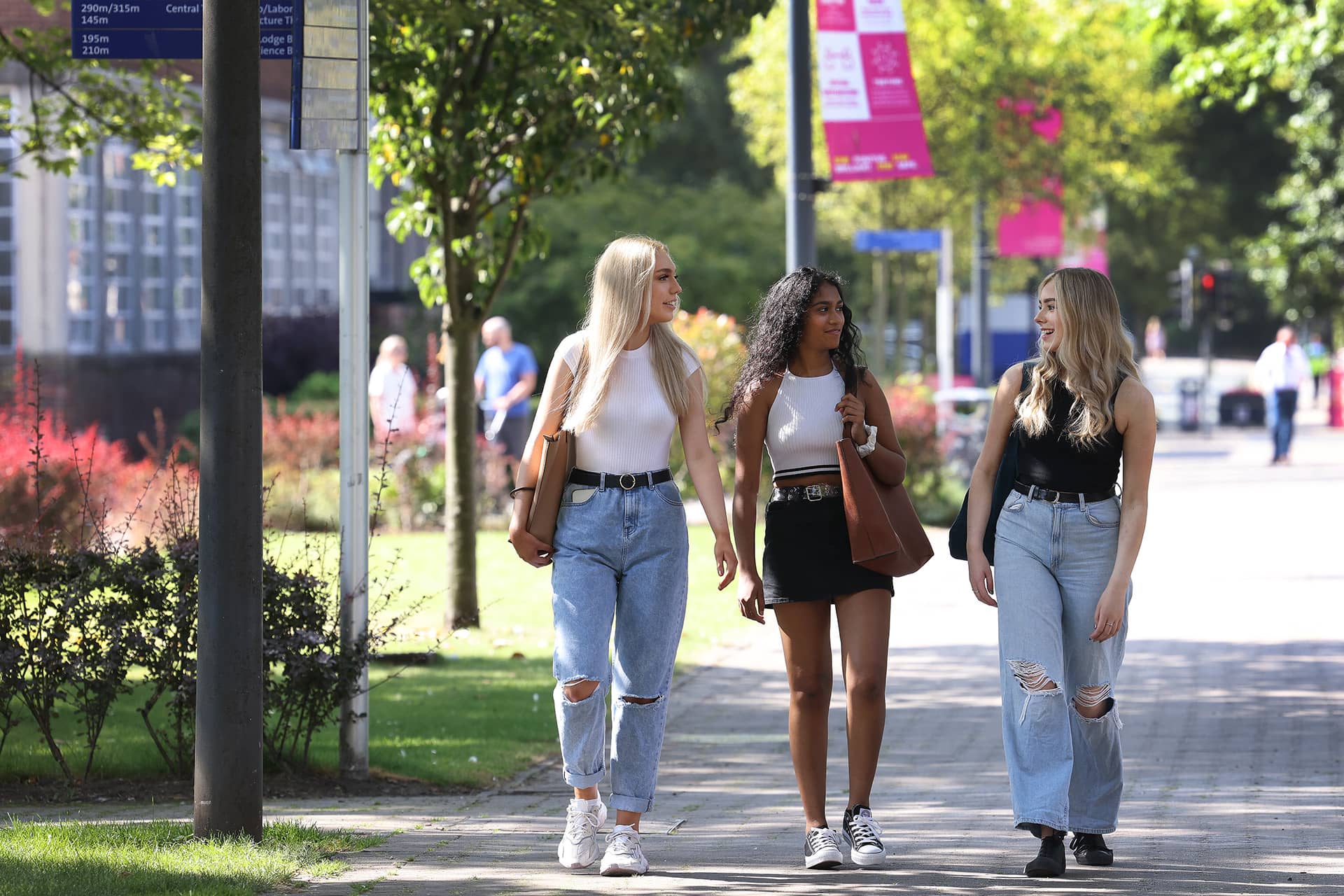 Group of students walking through leafy campus