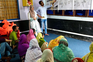 Two people standing in front of a classroom