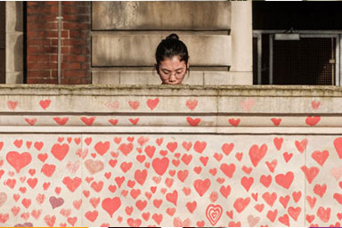 A woman at the COVID Memorial Wall