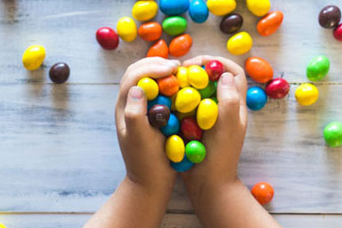 Child's hands holding sweets