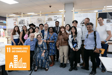 A group of people standing in front of display boards