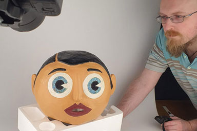 Frank Sidebottom's mask being photographed