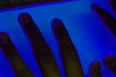 Silhouette of a hand against a blue background