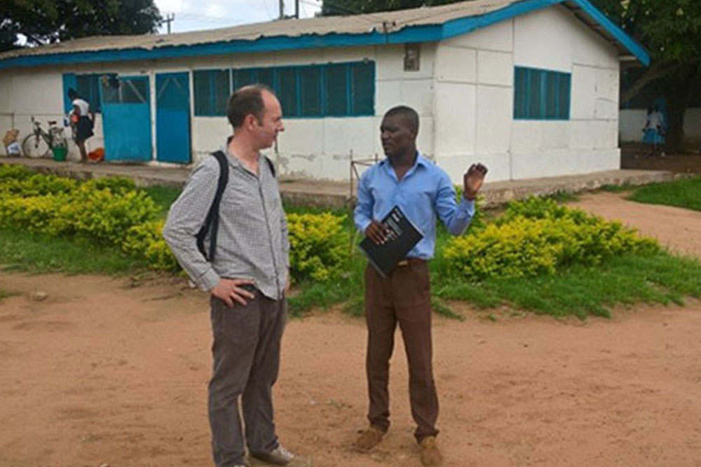 Two men standing in an African village