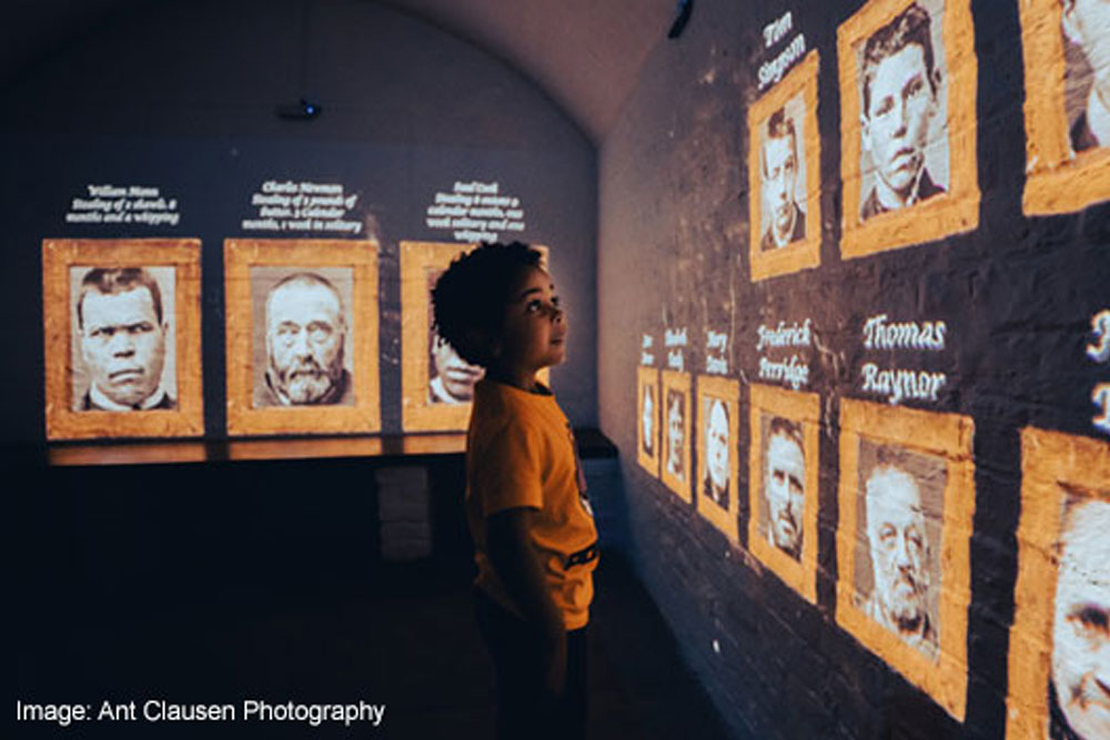 A young boy looking at projections on a wall