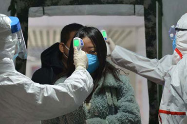 A woman having her temperature taken