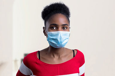 A Black woman wearing a facemask