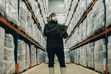 A warehouse worker in PPE