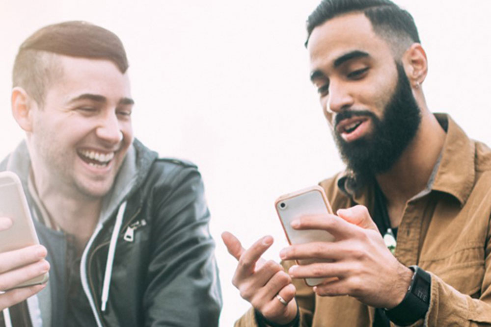 Two men looking at their phones