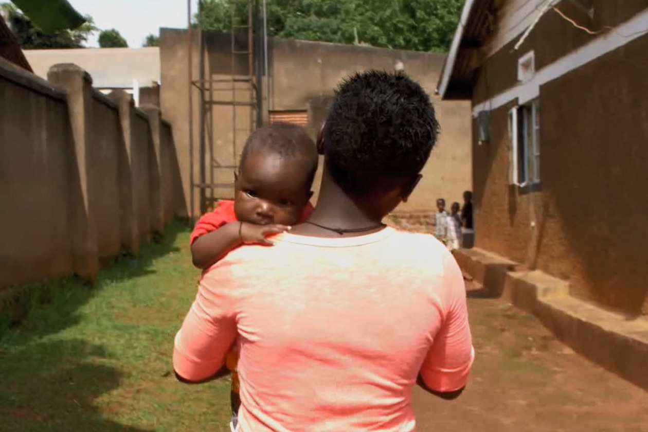 Mother walking carrying baby