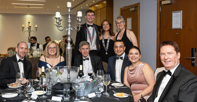 Group of guests sitting around a dinner table