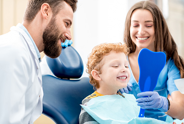 parents and child at the dentist