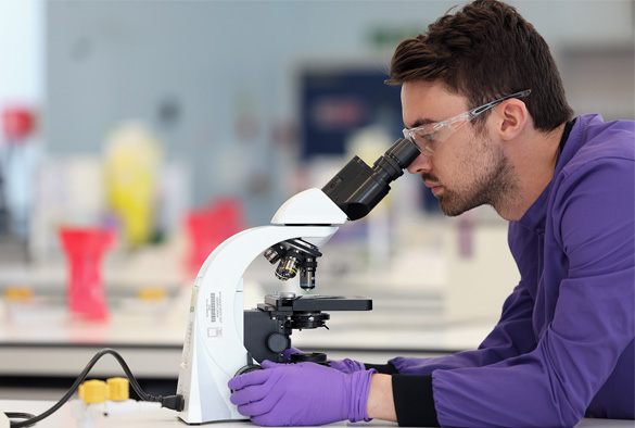 a person using a microscope