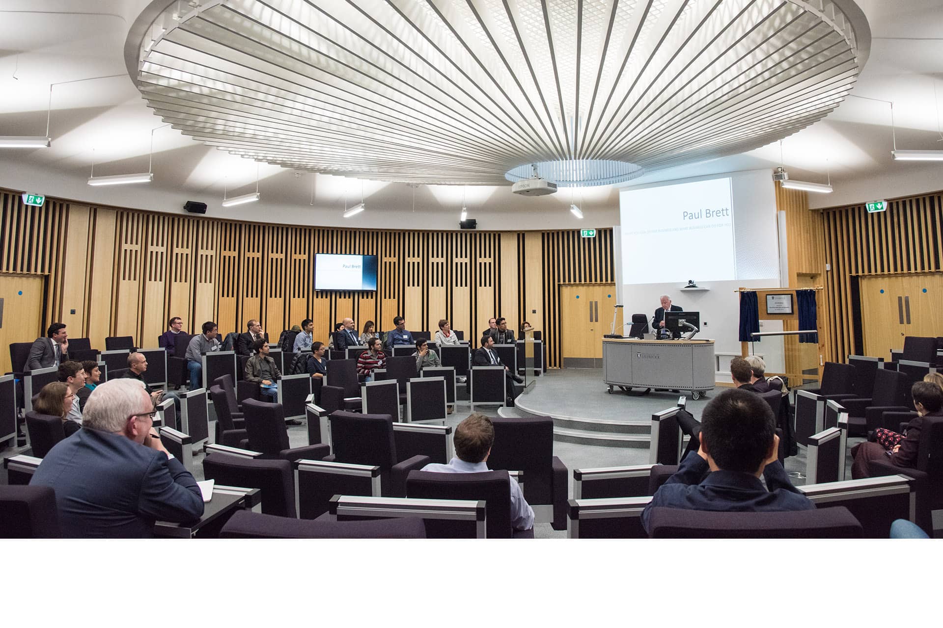 People listening to a talk in the Brett Building