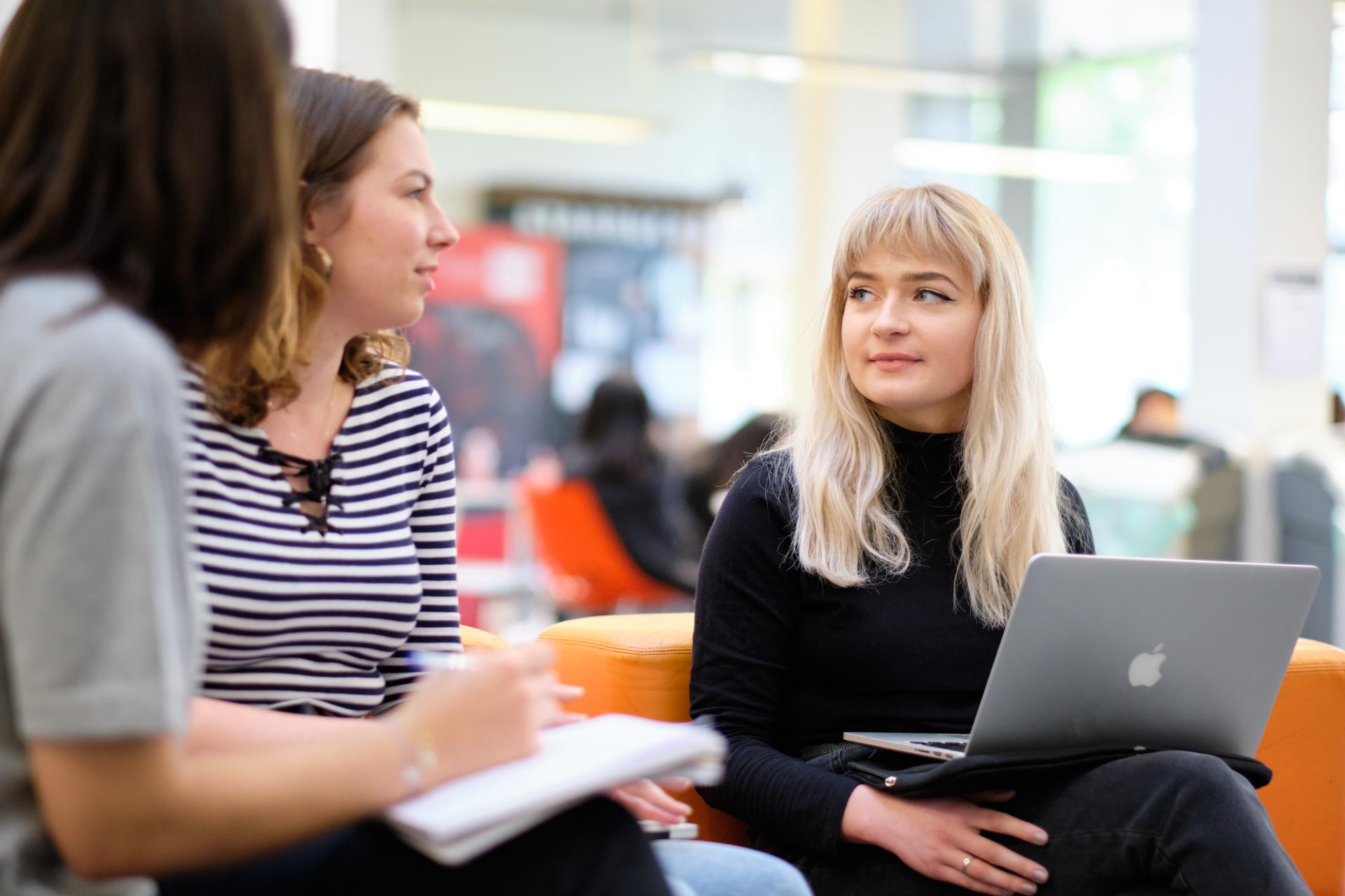 Female students discussing group work after classes
