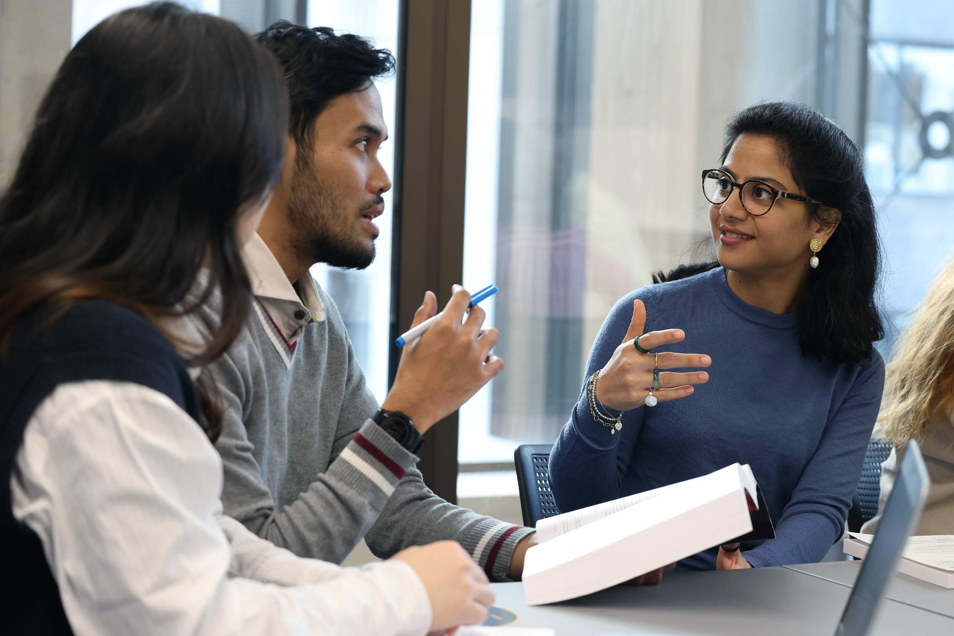Students discussing group work in a classroom