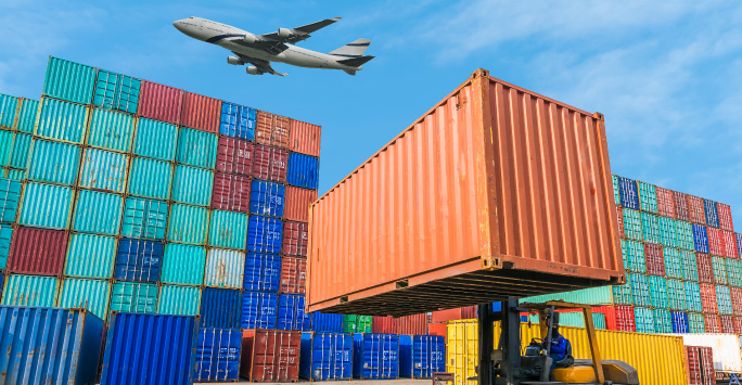 Port container being transported by a crane