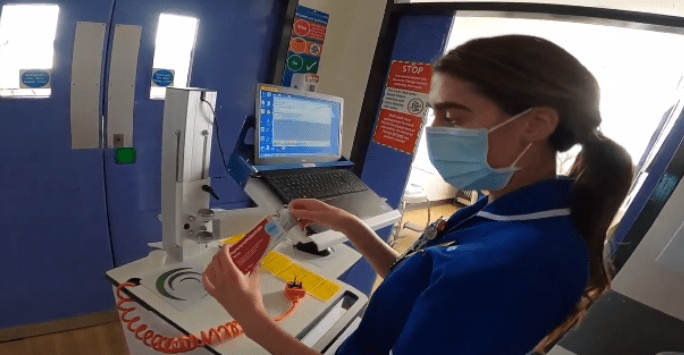 nurse in mask distributing medication