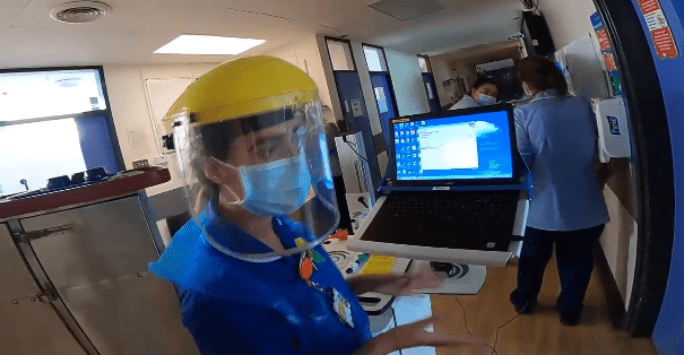 nurse in visor distributing medication