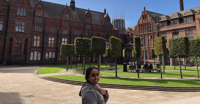 smiling student in green square with blue sky