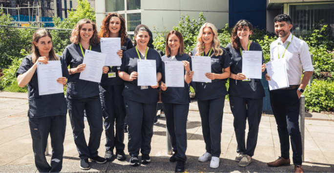 a group of students pose with certificates