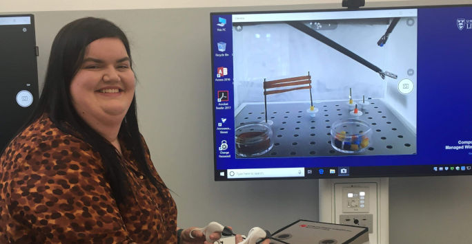 student using virtual surgical equipment interacting with a computer screen