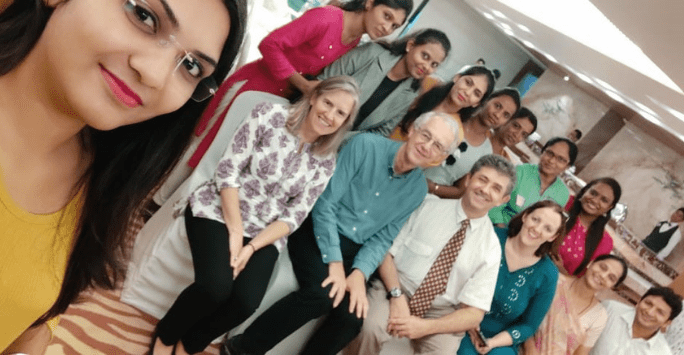 two rows of people posing to camera for group picture