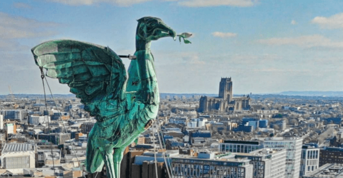 The liver bird on top of the royal liver building with the city and cathedral as backdrop