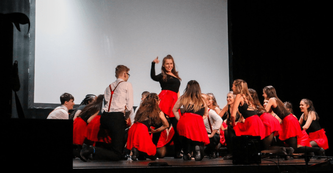 dancers perform on stage