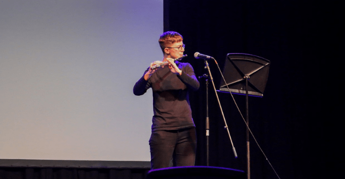 a performer on stage playing the flute