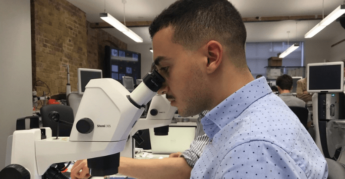 student using a microscope